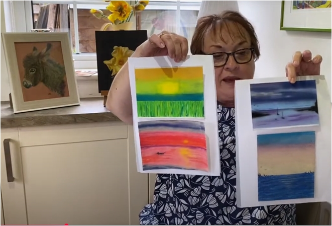 Wendy Reynolds, soft pastel student of Sue Kerrigan-Harris, holding her artwork proudly